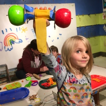 Creative Re-use: making weights out of fake apples, paper tubes, masking tape, and crepe paper.